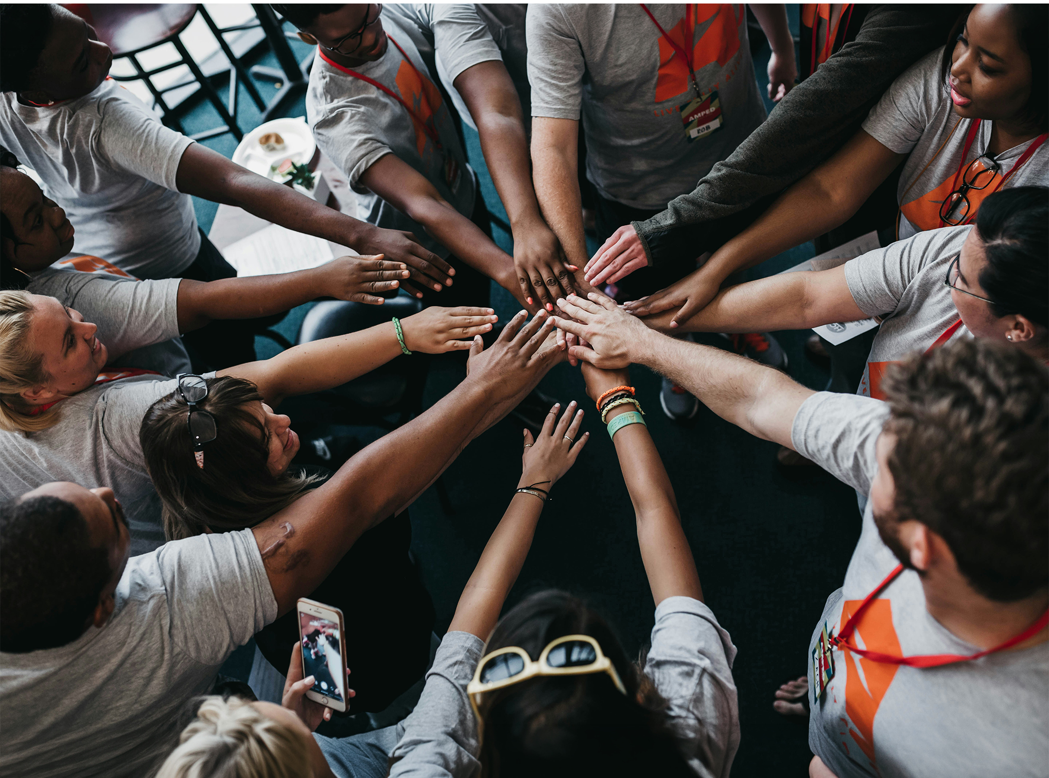 People putting their arms all in for a team building hurrah.